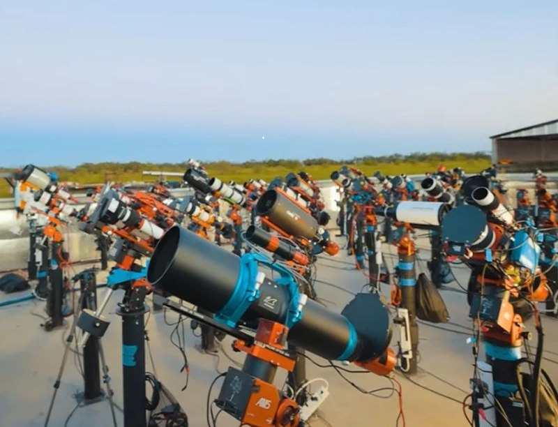 Ranks of telesopes on piers at Starfront Observatory, Texas